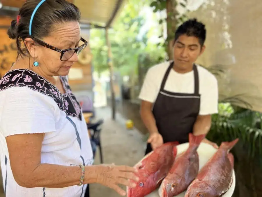 Gina Machorro selecting fish at El Horno Escondido.
