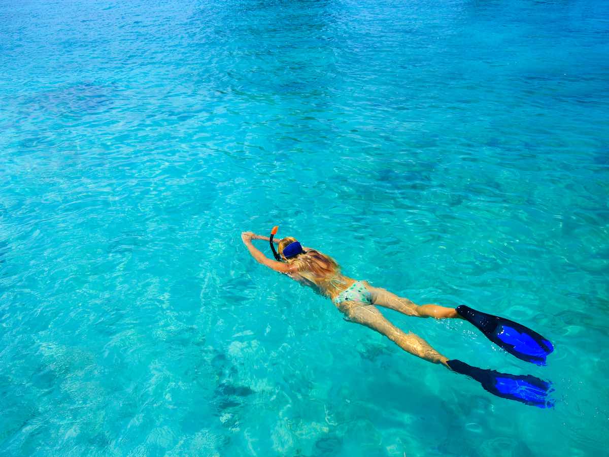 Young woman snorkeling in Bahamas. 