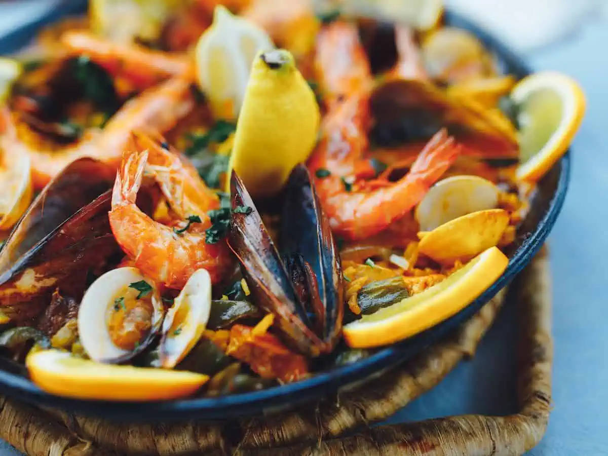 Seafood paella brimming in a pan.  