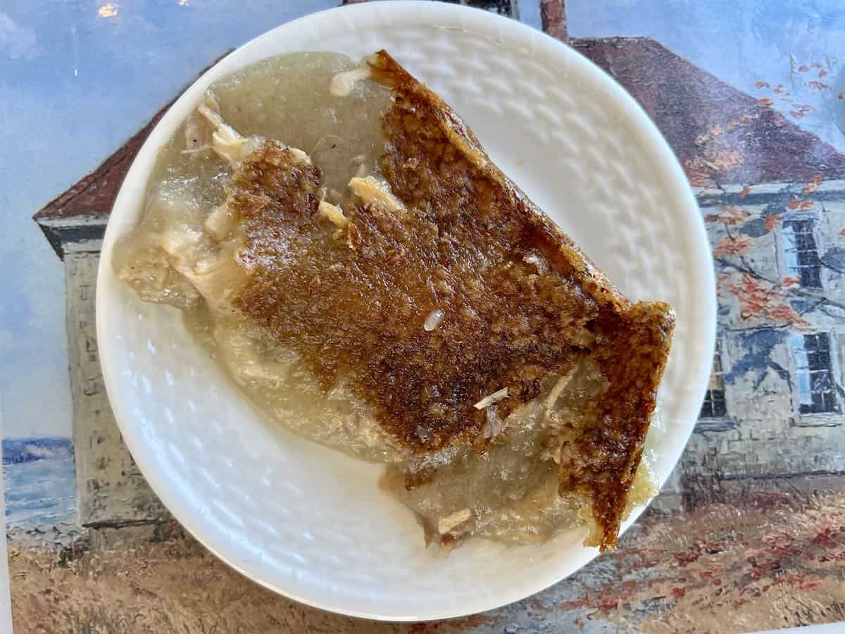A white plate of chicken rappie pie .