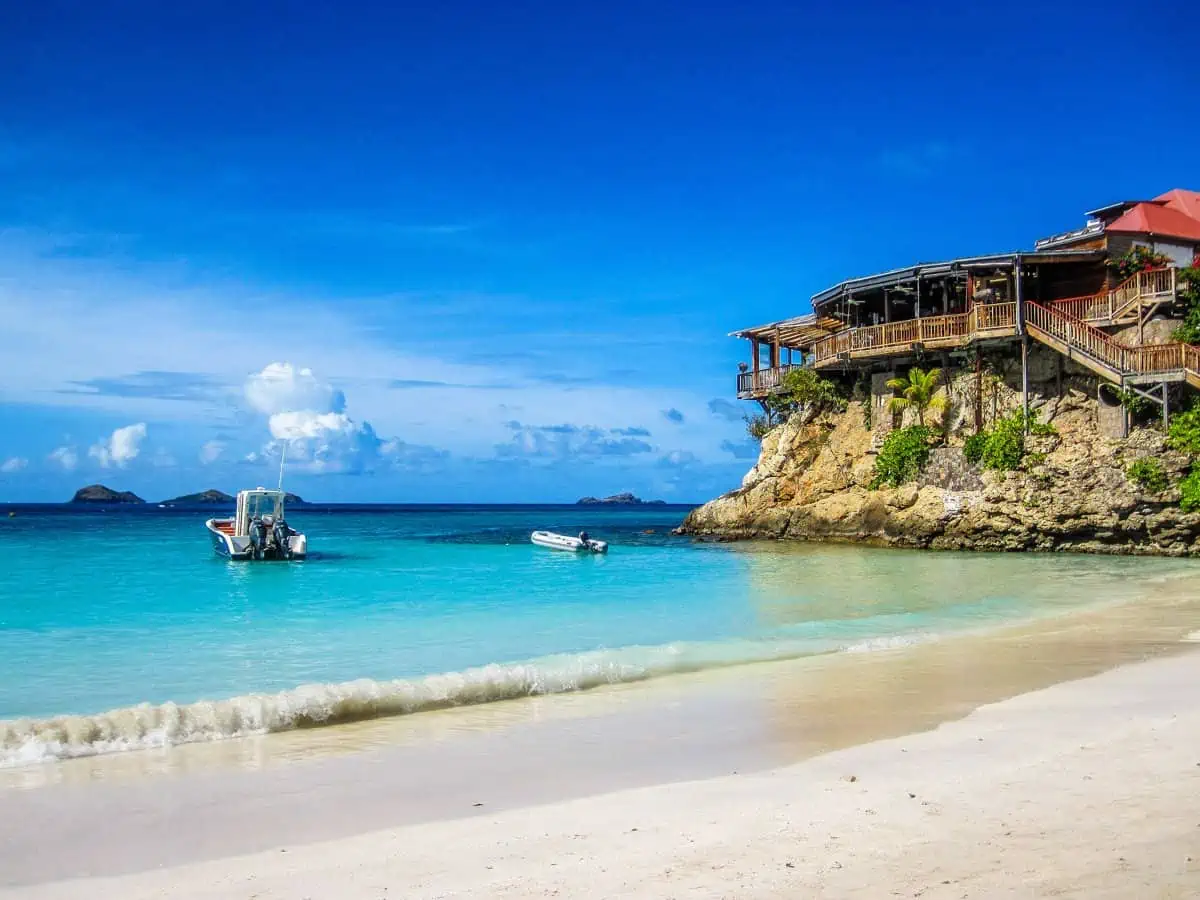 Ocean view with building on top of a rock.