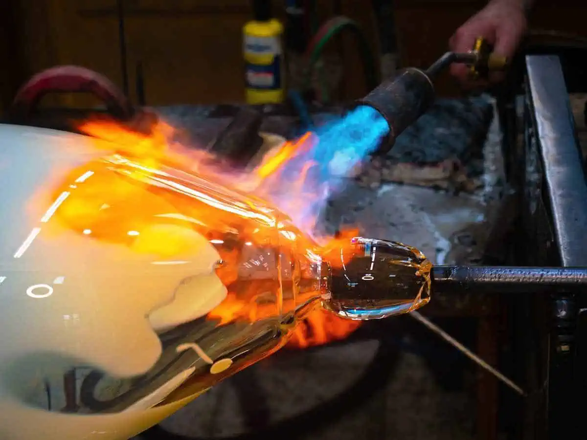 Artist doing glass-blowing by hand.  