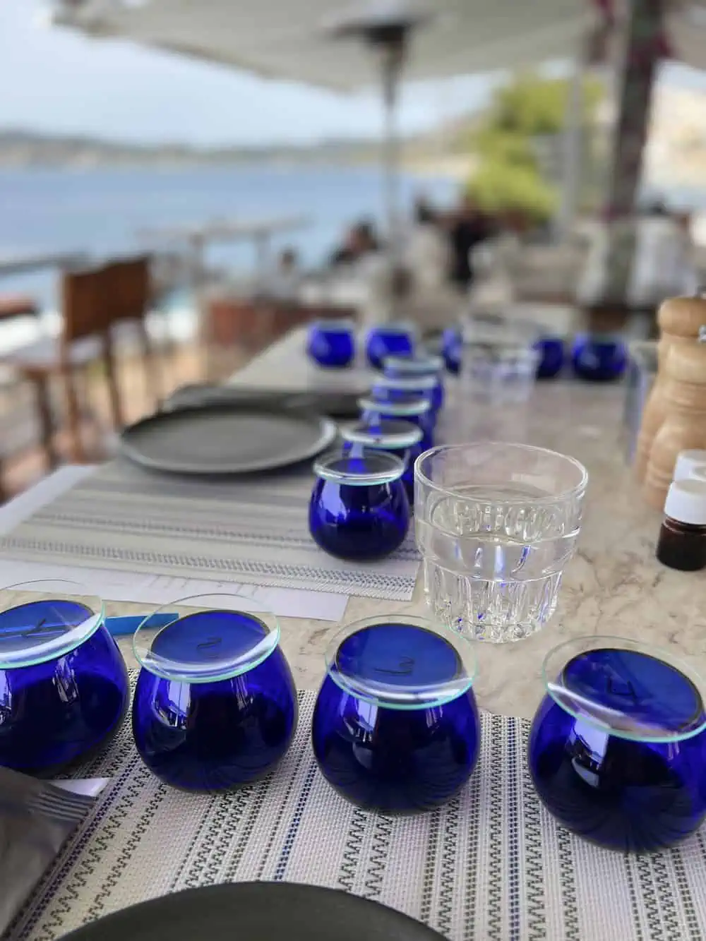 Blue tumblers on a table for an olive oil tasting.  