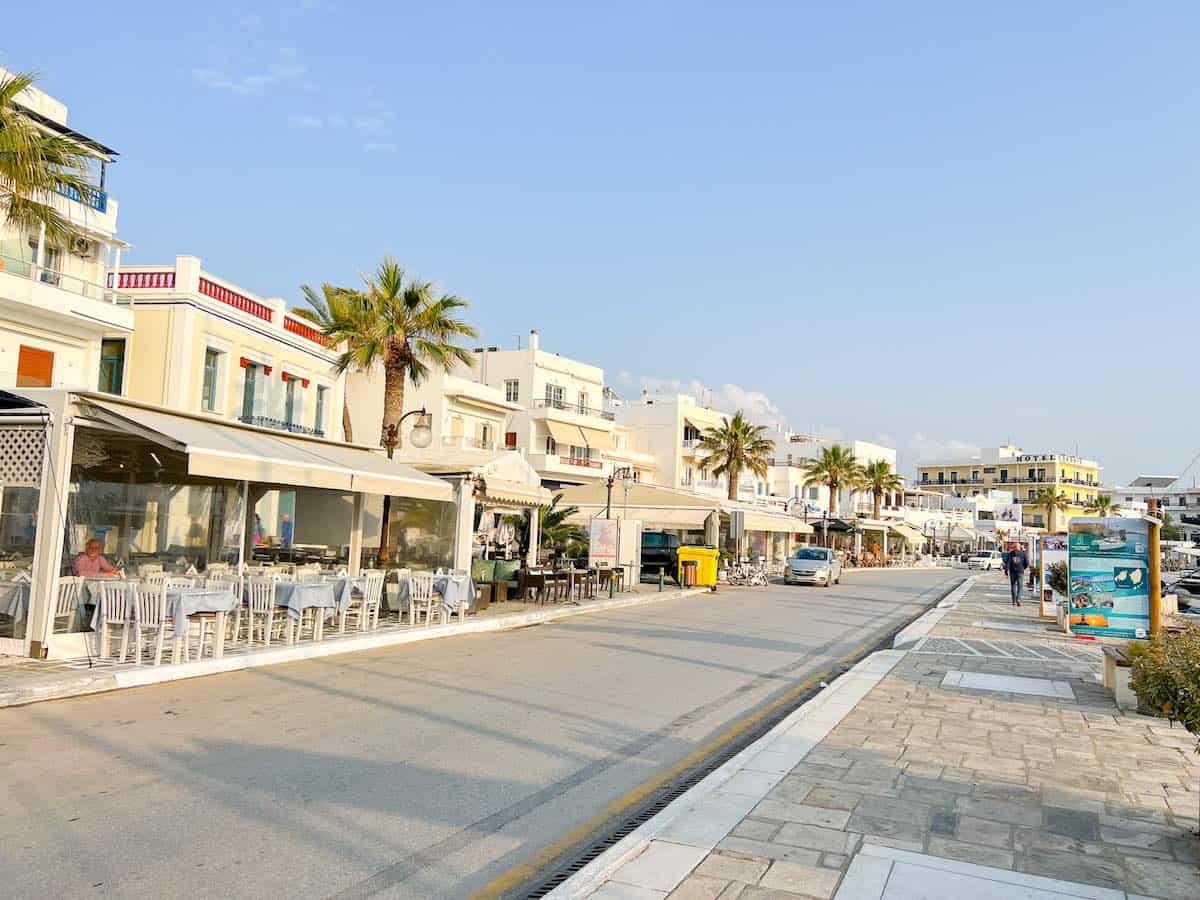 Tavernas lining the harbourfront in Chora at sunset.