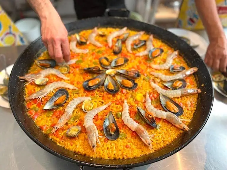 Chef making paella at a cooking class in Barcelona.