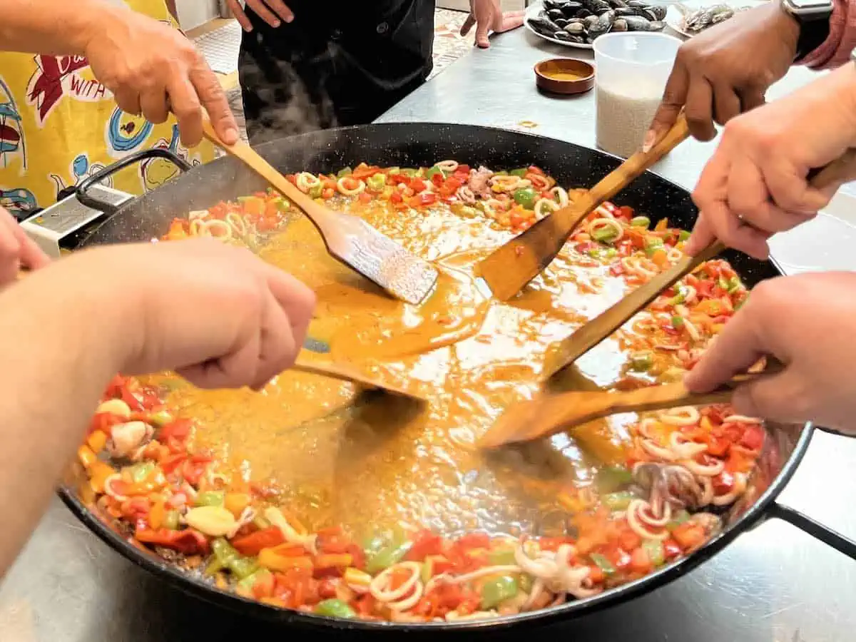 People making paella in a cooking class in Barcelona. 