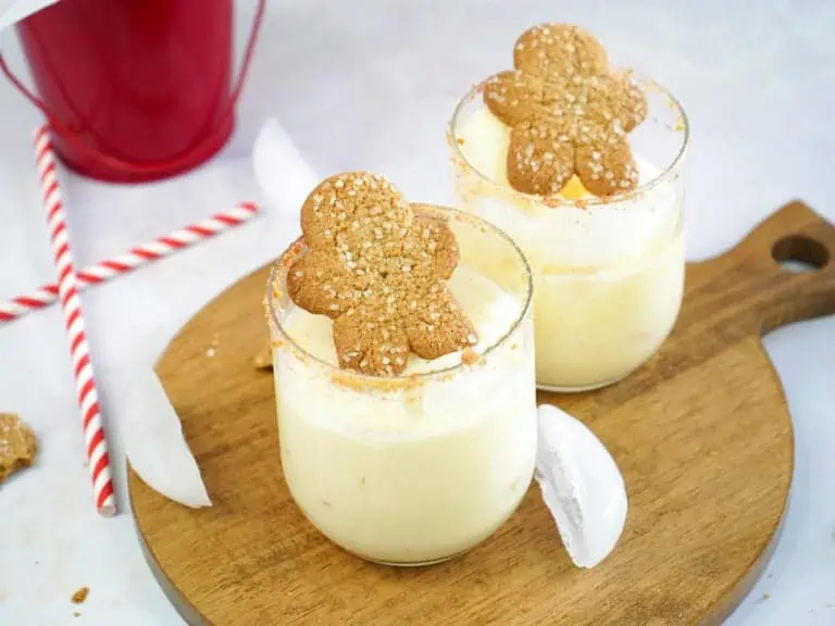 Two glasses of eggnog cocktails with rum and brandy on the table ready to enjoy.