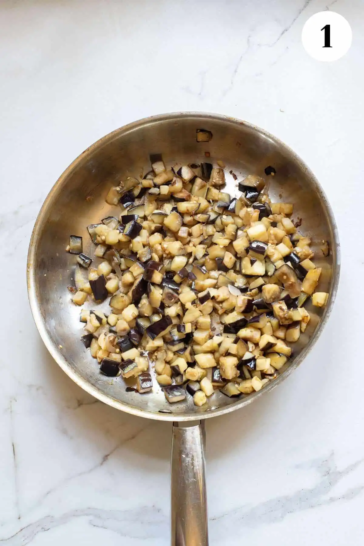 Cooking the eggplant in a skillet.