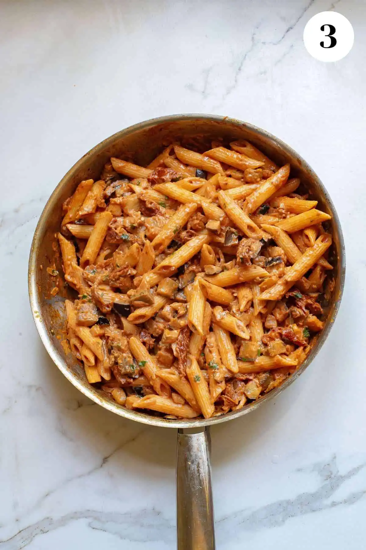 Pasta and tomato paste added to the skillet.