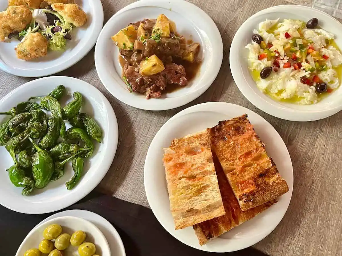 Esqueixada de bacalao (top right) served along with other popular traditional tapas in Barcelona, Spain.