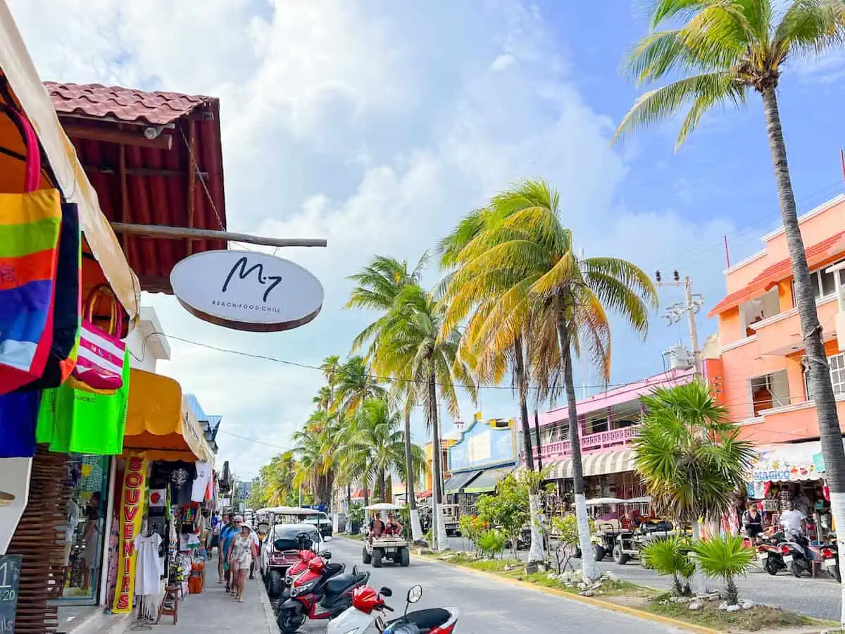 The Centro area of Isla Mujeres with tourist stores, motorcycles and golf carts. 