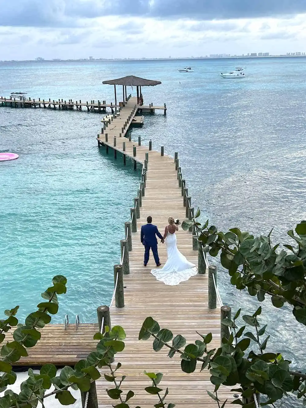 Couple on a wedding pier at Secrets Isla Mujeres. 