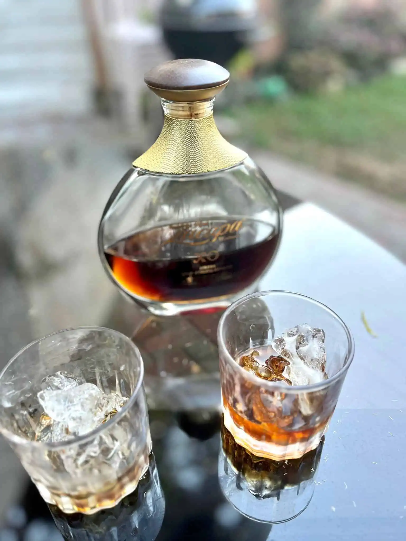 A bottle of Zacapa rum with two glasses with ice. 