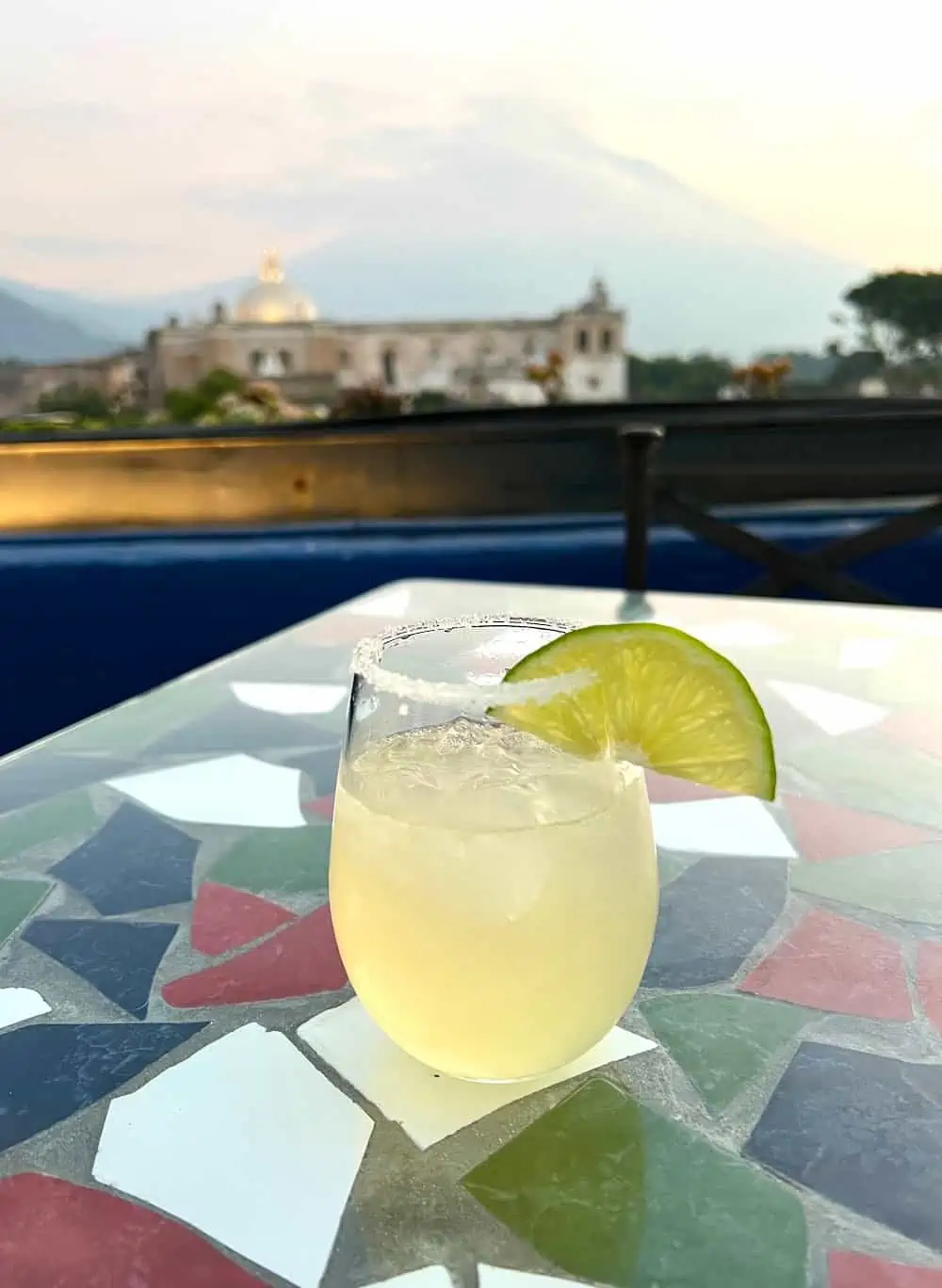 A cocktail at Sky Bar in Antigua with a view of a volcano. 