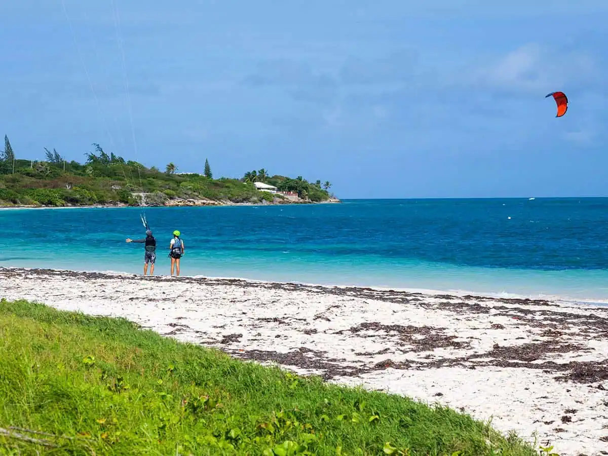 Two people preparing to windsurf.