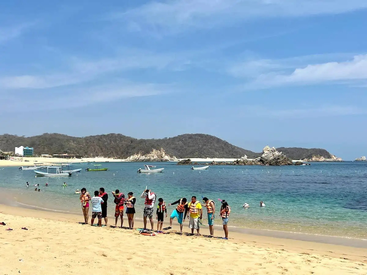 A group of people snorkeling on an excursion in Huatulco.