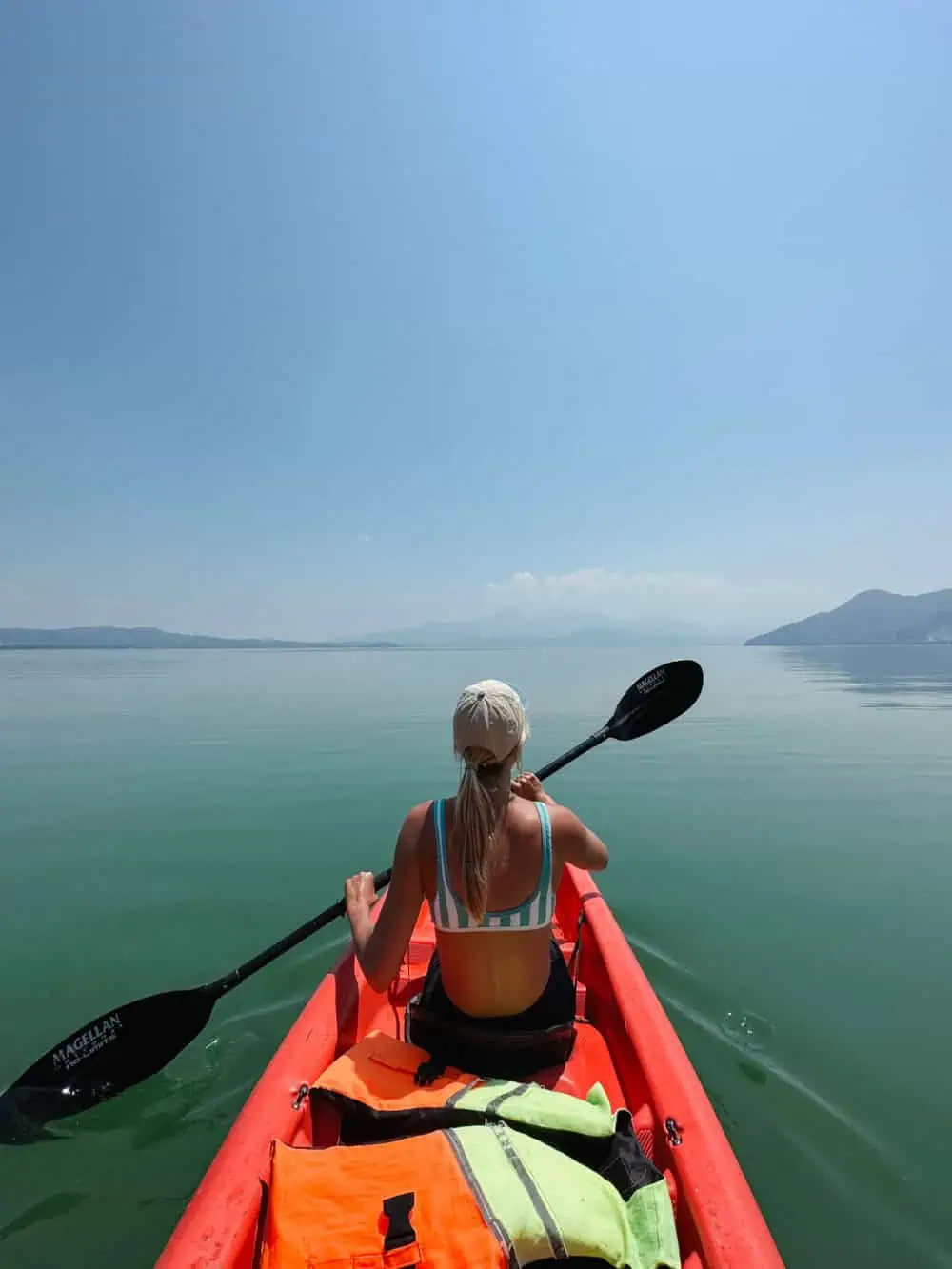 A woman kayaking  on Lake Yojoa.