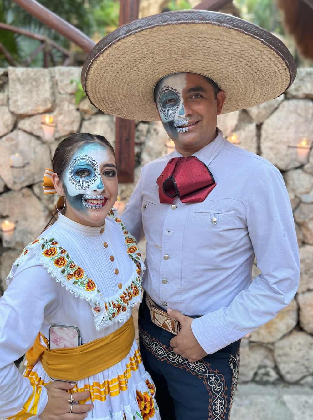 Two people with faces painted at Xcaret Park. 
