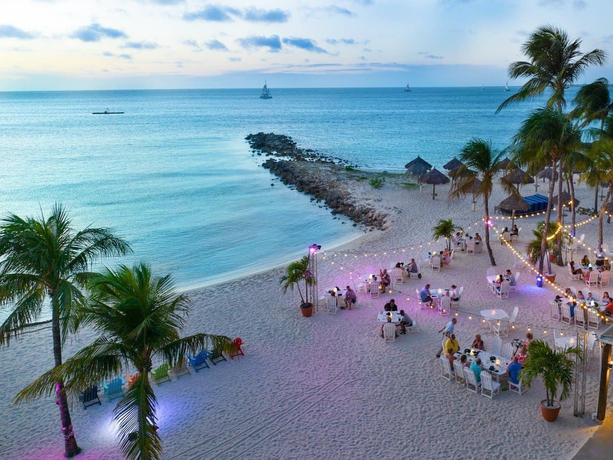 Aerial view of romantic scene of dining on the beach at Pureocean restaurant in Aruba.