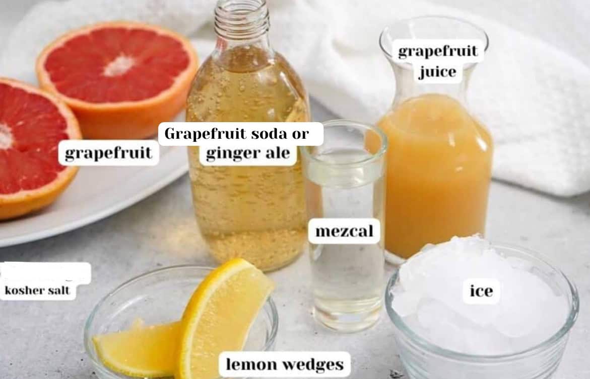 Ingredients for Mezcal Paloma cocktail including grapefruit, grapefruit soda or ginger ale, lemon or lime, mezcal and fresh grapefruit juice.  