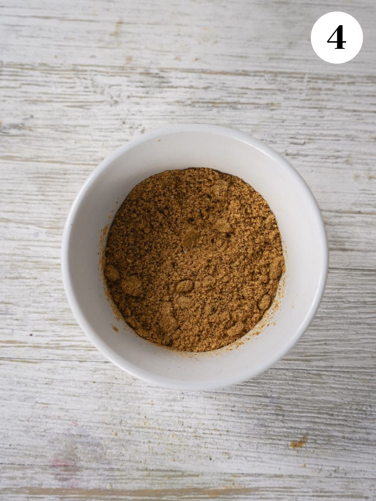 Ground pumpkin seeds added to a small dish.