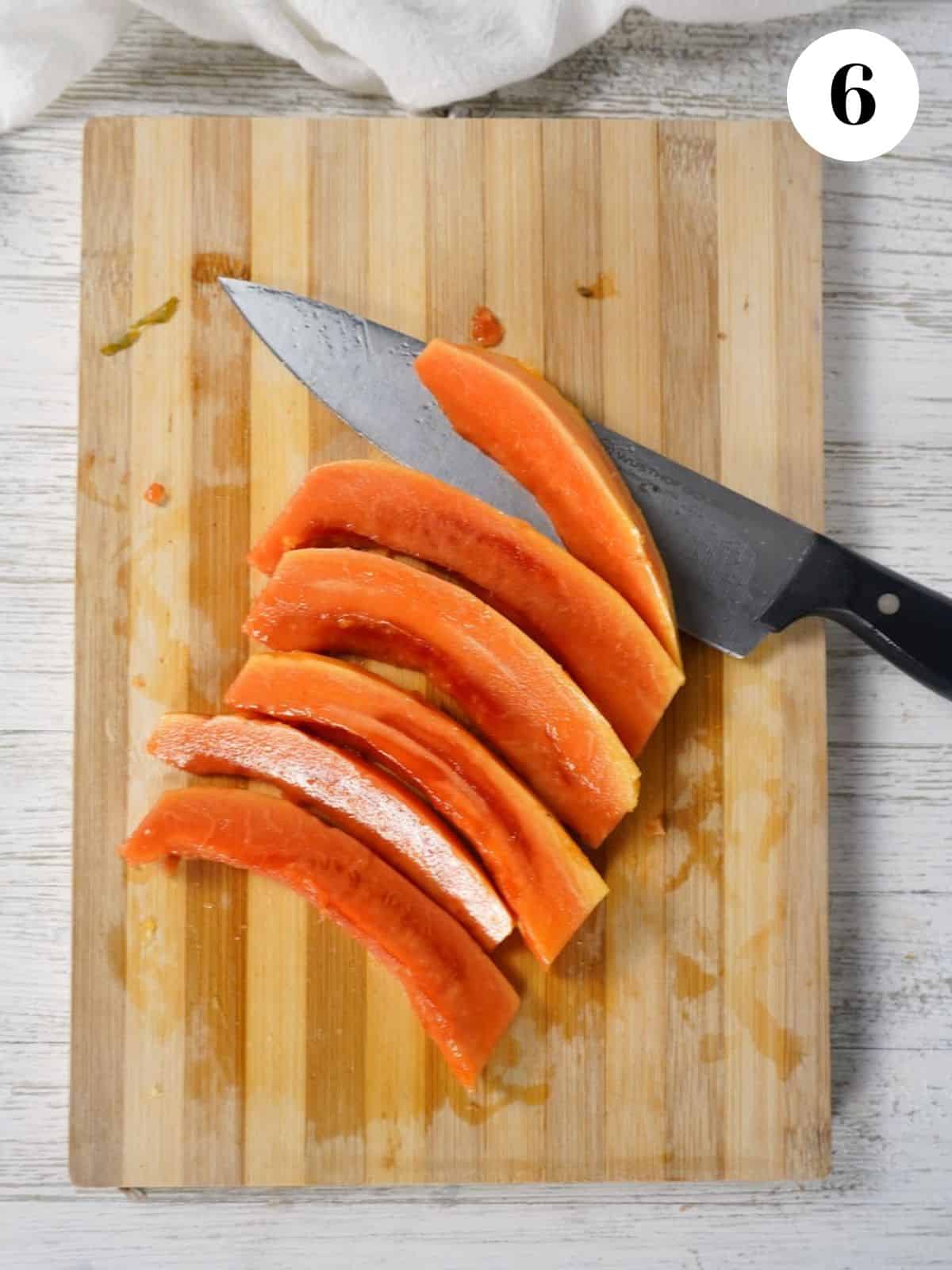 Papaya sliced on a cutting board.